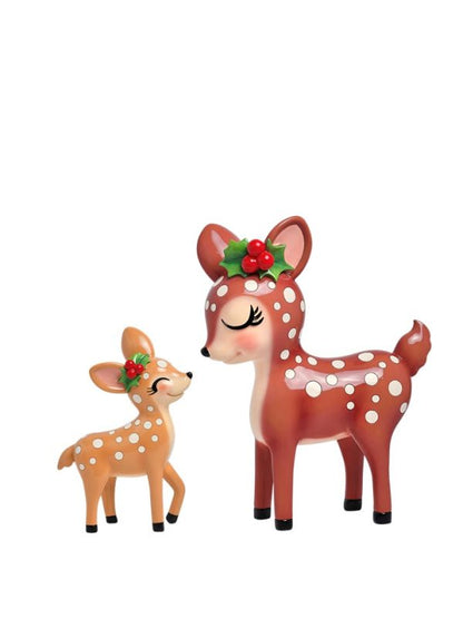 Two Christmas-themed deer figurines, one adult brown deer with white spots and one smaller tan deer with white spots, both wearing red berry holly crowns, on a plain white background.